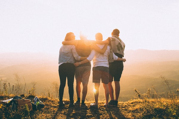Group of teenagers in front of a sunset