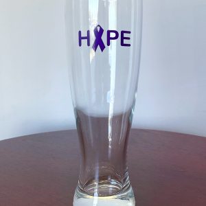 Tall drinking glass with Hope written on it