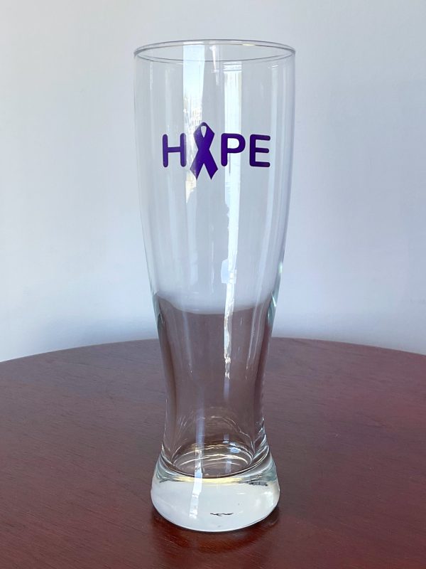 Tall drinking glass with Hope written on it