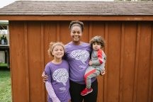 Woman hugging two children